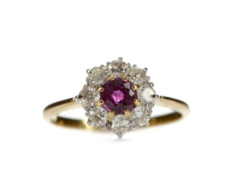 RUBY AND DIAMOND RING, set with a round ruby of approximately 0.63 carats within a halo of Old European cut diamonds totallin