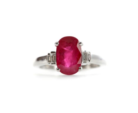 RUBY AND DIAMOND RING, set with an oval ruby of approximately 3.01 carats on baguette cut tiered diamond shoulders, in eighte