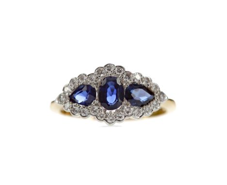 SAPPHIRE AND DIAMOND RING, set with an oval sapphire flanked by two pear shaped sapphires totalling approximately 0.98 carats