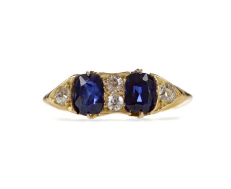 SAPPHIRE AND DIAMOND RING, set with two cushion shaped sapphires totalling approximately 0.95 carats interspaced by round bri