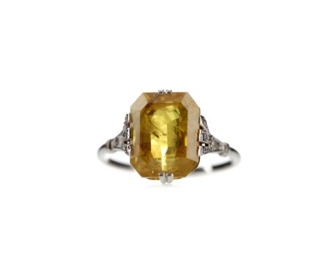 YELLOW SAPPHIRE RING, set with an octagonal step cut yellow sapphire of approximately 7.03 carats, with rose cut diamond set 
