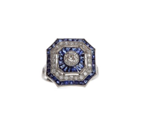 SAPPHIRE AND DIAMOND RING, the central old cut diamonds bordered by sapphires and round brilliant cut diamonds. with sapphire