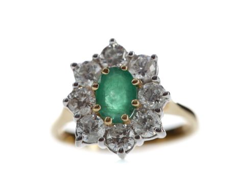 EMERALD AND DIAMOND CLUSTER RING, set with an oval emerald of approximately 1.15 carats within a halo of round brilliant cut 