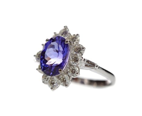 TANZANITE AND DIAMOND RING, set with an oval tanzanite of approximately 3.66 carats with accompanying WGI report number WGI96