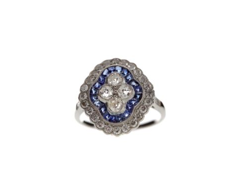 SAPPHIRE AND DIAMOND RING, set with four Old European cut diamonds bordered by calibre cut sapphires totalling approximately 