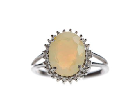 OPAL AND DIAMOND RING, set with a cabochon opal within a halo of round brilliant cut diamonds totalling approximately 0.25 ca