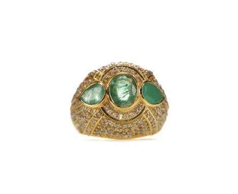 EMERALD AND DIAMOND RING, set with an oval emerald flanked by two pear shaped emeralds, to a pave set diamond bezel, silver g