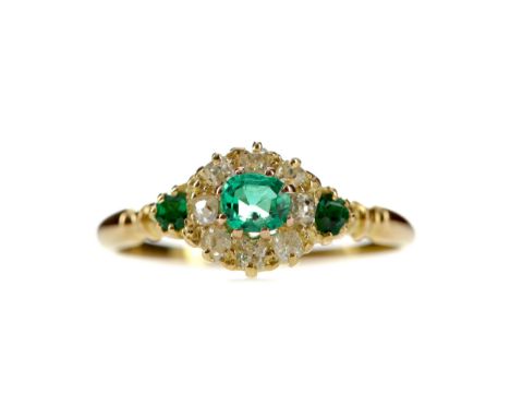 EMERALD AND DIAMOND RING, set with three emeralds totalling approximately 0.25 carats surrounded by old mine cut diamonds tot