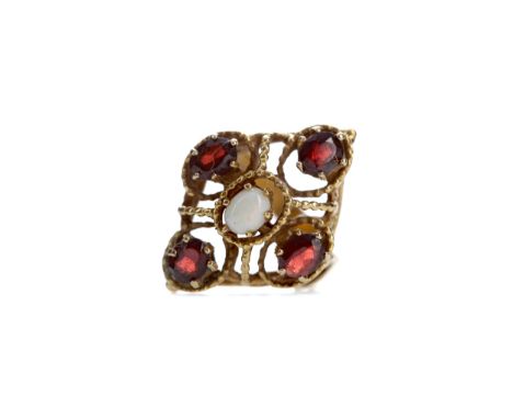 GARNET AND OPAL CLUSTER RING, set with a central cabochon opal flanked by four garnets to an openwork setting, in nine carat 