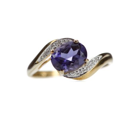 IOLITE AND DIAMOND RING, set with an oval iollite bordered by round brilliant cut diamonds totalling approximately 0.08 carat