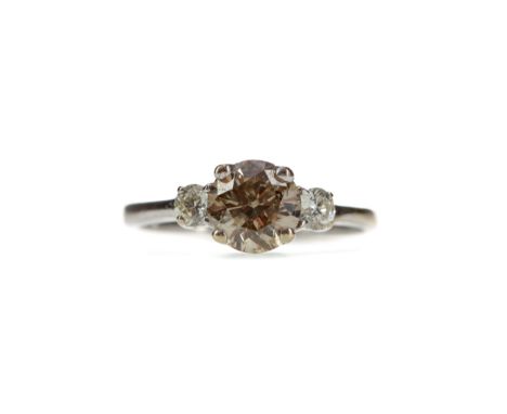 DIAMOND THREE STONE RING, set with a central cognac round brilliant cut diamond of approximately 1.01 carats flanked by two c