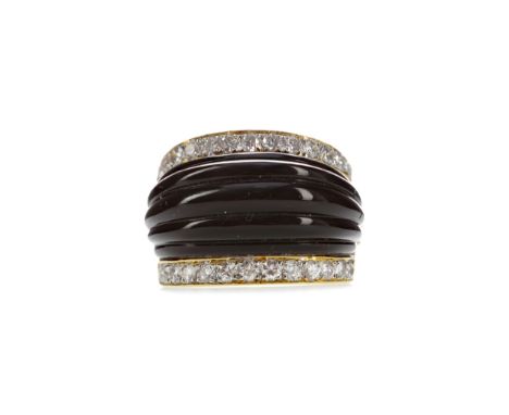 BLACK HARDSTONE RING, with raised black hardstone bordered by round brilliant cut diamonds totalling approximately 0.52 carat