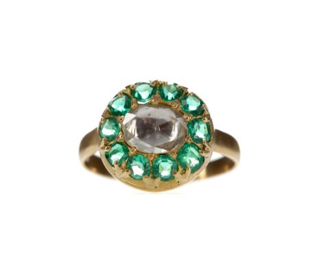 EMERALD AND DIAMOND RING, set with a foil backed rose cut diamond of very approximately 1.20 carats, within a halo of emerald