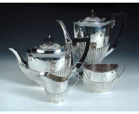 A matched four piece silver tea and coffee set, comprising:- a coffee pot by Harrison Brothers & Howson, Sheffield 1902, of o