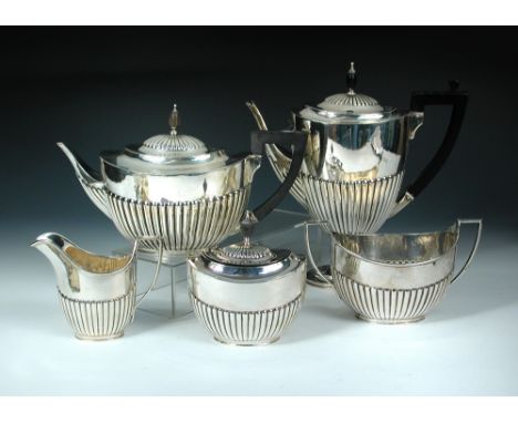 A matched mainly Victorian five piece silver tea set, principally by Edward Hutton, London 1890 & Sheffield 1890, comprising: