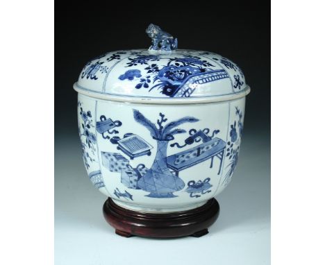 A Chinese Kangxi period blue and white bowl, cover and wood stand, each painted with four divisions of precious objects, the 