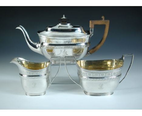 A George III silver three piece tea set, by John Emes, London 1807, the teapot of rectangular shape with moulded girdle engra