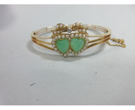 A double heart chrysoprase, seed pearl and diamond hinged bangle, the two heart-shaped cabochons of soft green chrysoprase in