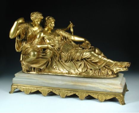 A large Barbedienne gilt bronze group of the Fates, Clotho seated holding a spindle and Atropos lying holding a scroll and a 