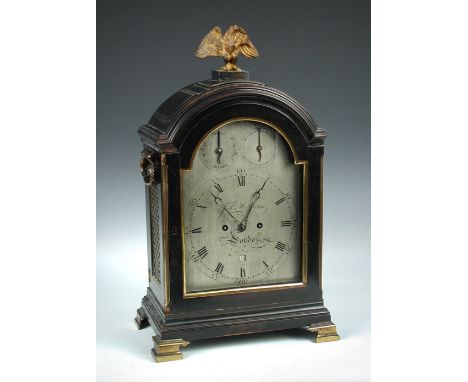 A George III ebonised fruitwood bracket clock, the triple pad top with gilt metal eagle finial above break arch silvered 8inc