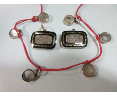 A small collection of early 19th century memento jewellery, six small circular glazed pendants containing locks of children's