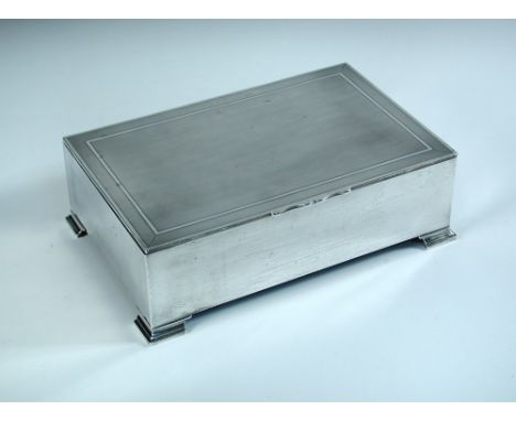 A large silver cigarette/cigar box, by Mappin and Webb, Birmingham 1929, of rectangular shape raised on four bracket feet, th