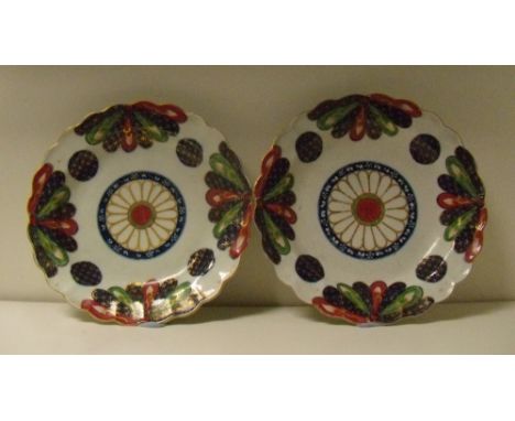 A pair of first period Worcester fan pattern plates, the central gilt rosettes enclosed by four gilt blue roundels, the flute