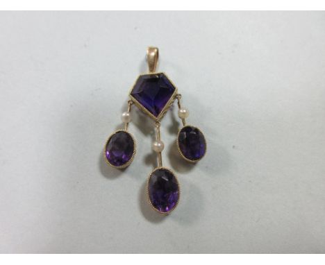 An unusual antique amethyst and seed pearl pendant, composed of a pentagonal cut deep purple amethyst in a millegrain collet 