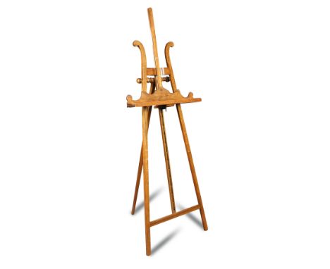 A late Victorian walnut strut framed easel, with adjustable lyre shape shelf 168cm (66in)  A little old woodworm.