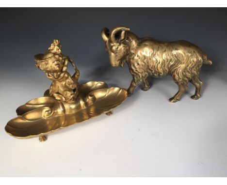 A 19th century polished bronze figure of a ram together with an inkstand, the ram walking with its horned head turned to one 