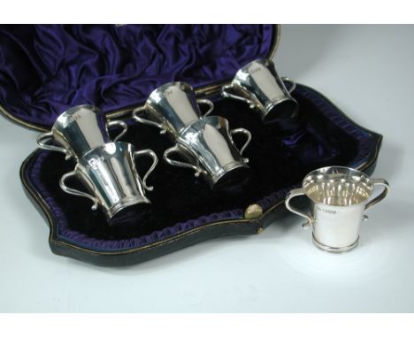 A set of six late Victorian silver two handled tot cups, by Wakeley and Wheeler, London 1900, of tapering cylindrical shape w