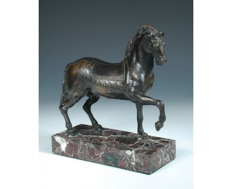 After the Antique, a bronze figure of a prancing horse, probably 18th century, he stands on a mottled red marble rectangular 