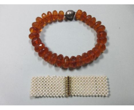 A vintage amber bead necklace and a pearl choker, the amber necklace a graduated string of 17-27mm faceted rondel beads to a 