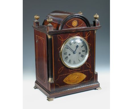 A mahogany and inlaid mantel clock, the break arch case with four corner finials above 14.5cm (5.75in) silvered dial, with Ro