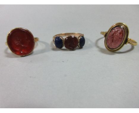Three antique intaglio set rings, the first with a carved cornelian portrait bust, possibly of a Roman emperor, with ribboned