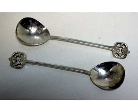 A pair of Arts and Crafts spoons, by A E Jones, Birmingham 1913, each with cast and hammered stem, the open finial with mirro
