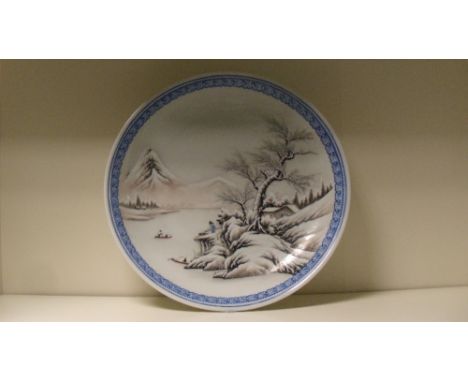 Attributed to He Xuren, a Chinese Republic Period dish painted with boats plying between snow clad islands within an overglaz