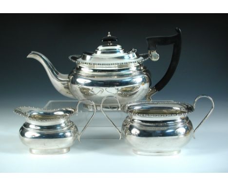 A silver three piece tea set, by Viners, Sheffield 1931, of plain compressed oblong form below a stylised beaded edge, 15.5cm