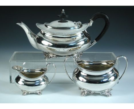 A three piece silver tea set, by the Atkin Brothers, Sheffield 1905, comprising a teapot of compressed oval form below a gadr