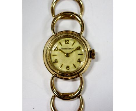 Jaeger-LeCoultre - a lady's 9ct cased wristwatch, the round dial with alternate gold coloured Arabic and baton numerals, sign