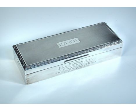 A silver table cigarette box, by P Ltd, Birmingham 1965, of rectangular form the cover with engine turned decoration within a