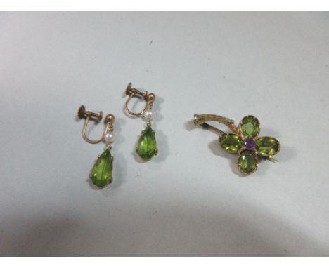 A peridot and amethyst brooch together with a pair of peridot and seed pearl earpendants, the brooch modelled as a cruciform 