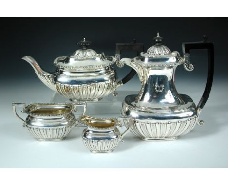 A matched four piece silver tea set, by Charles Boyton & Son Ltd, London 1912/1919, comprising:- a teapot (London 1912) of co