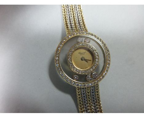 A lady's 18ct gold 'Happy Diamonds' wristwatch by Chopard, the circular brushed gold dial without numbers, signed Chopard, Ge