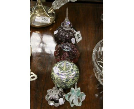 Two Okra art glass paperweights, two Caithness paperweights and an art glass scent bottle of fluted design 