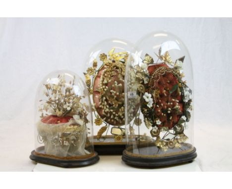 Three Victorian Glass dome covered Floral style displays in Wax, Ceramic, velvet cushion etc, largest example approx 50cm tal