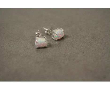 A pair of silver and opal stud earrings