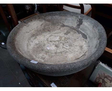 A LARGE ROUND STONE TROUGH