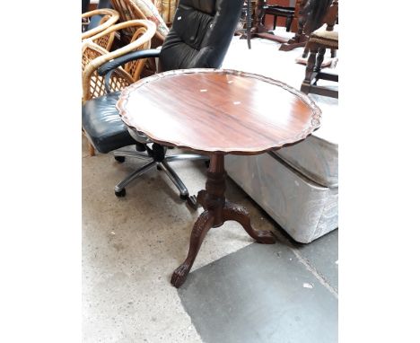 A REPRODUCTION TRIPOD TABLE WITH CARVED LEGS