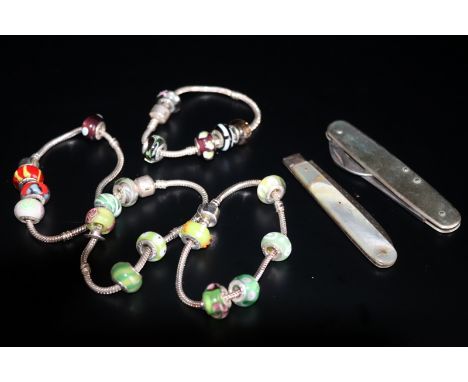 Small Mixed Lot Comprising 4 Charm Bracelets, A Silver Bladed Penknife And A Swiss Army Knife